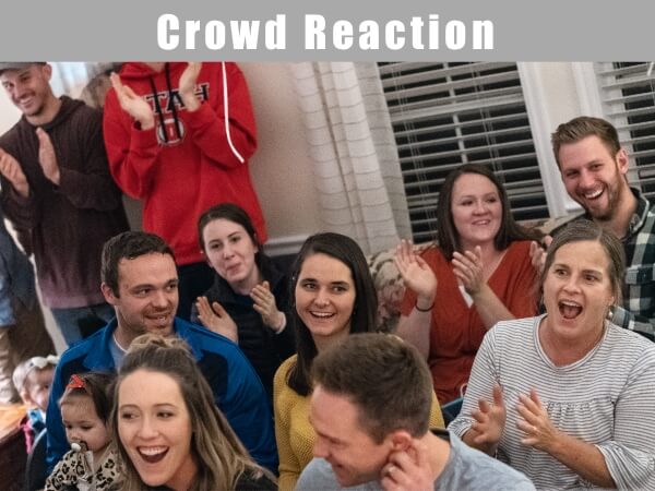 Crowd responding to gender reveal magic show